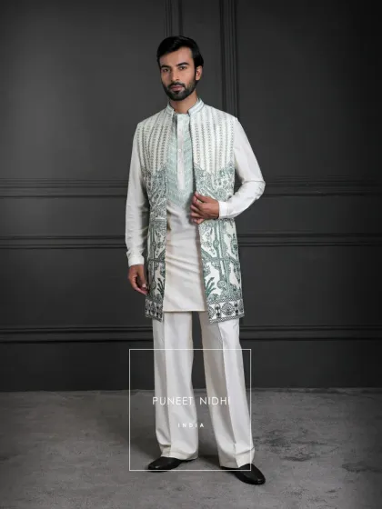 For lighter celebrations, I created this ivory kurta set with a mint threadwork jacket. The crisp tailoring and intricate botanical embroidery offer a look of effortless sophistication, perfect for day events and festive gatherings.