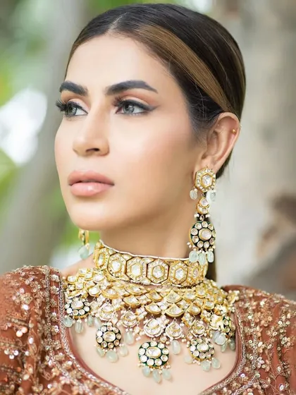 A minimal bridal look perfect for a day wedding. The makeup focuses on a soft base, nude glossy lips, and sleek hairstyling, creating a look that is chic, modern, and effortlessly elegant.