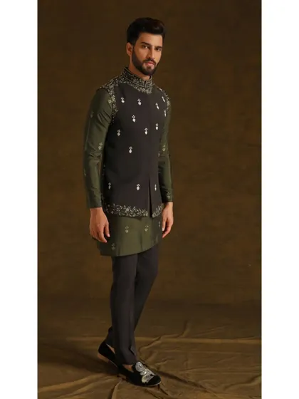 The Vedik Vigyaan bandi set. An olive green kurta is layered with a dark grey embroidered vest, creating a unique and earthy color combination for a sophisticated look.