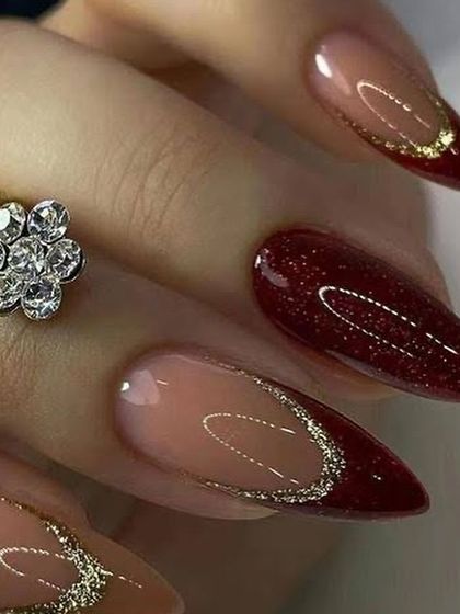 A dramatic and romantic wedding nail idea. This set combines deep red glitter nails with negative space accents outlined in fine silver glitter.