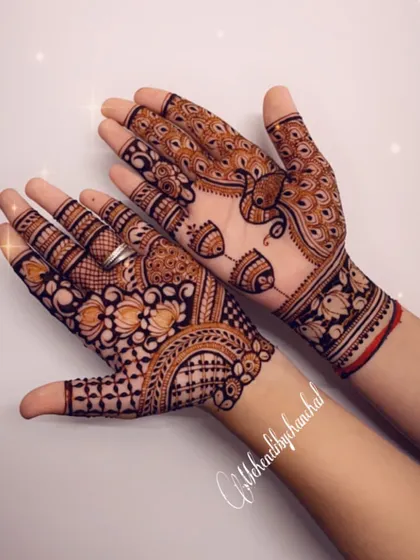 A simple and pretty Diwali design with peacocks and fish motifs on the back of the hands.