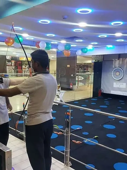 An instructor helps a participant with her form. We offer personalized attention to everyone in a group to make sure they learn the basics correctly.
