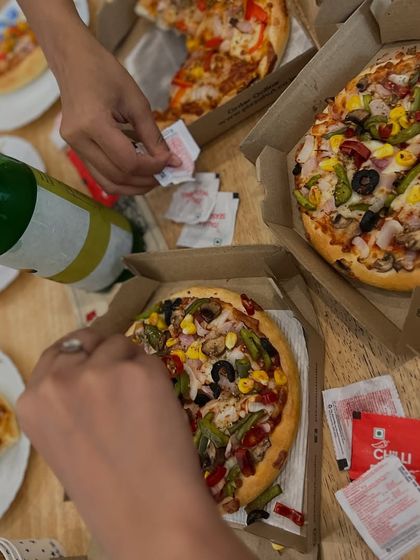 An overhead shot of our favorite community fuel: pizza. These informal gatherings are where friendships are formed and our tribe grows stronger.