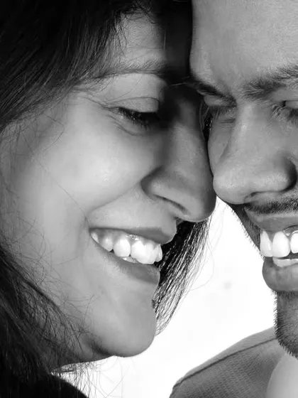 A candid, close-up couple portrait in black and white. I love capturing these genuine moments of laughter and connection, which make for timeless and emotional photographs.