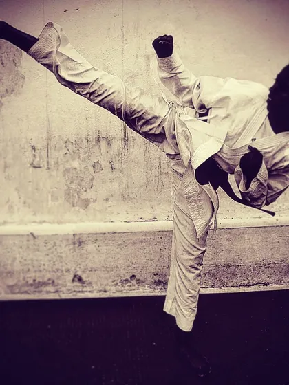 A perfect Mawashi Geri, or roundhouse kick, is a thing of beauty and power. This image captures the grace and strength we cultivate in all our students, turning their bodies into instruments of self-defense.