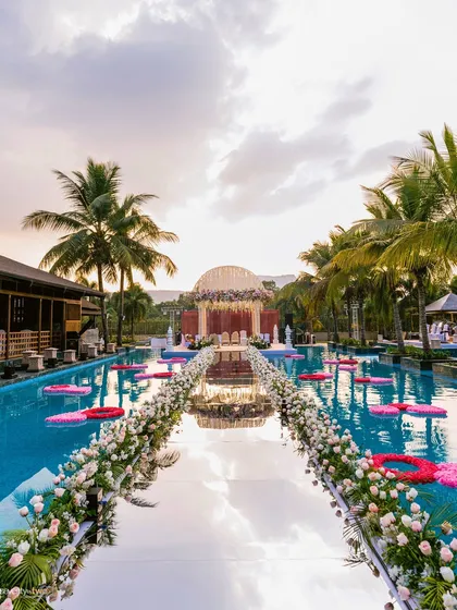 Imagine walking on water to meet your forever. For Aishwarya and Zankheel's wedding in Karjat, we captured this cinematic varmala ceremony on a mirrored aisle built over the resort pool, creating a moment that felt like a scene from a dream.