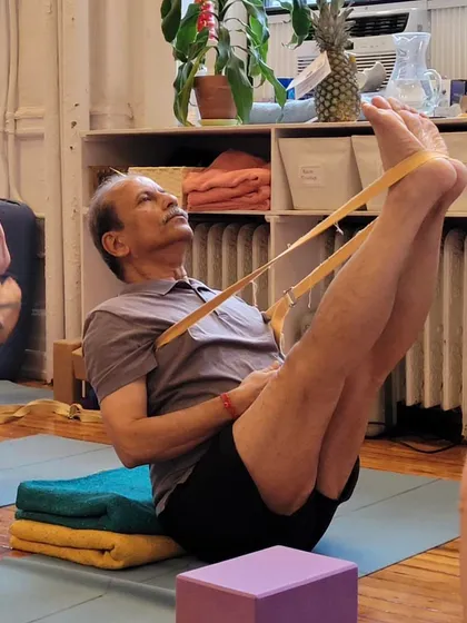 Navasana (Boat Pose) with a strap.