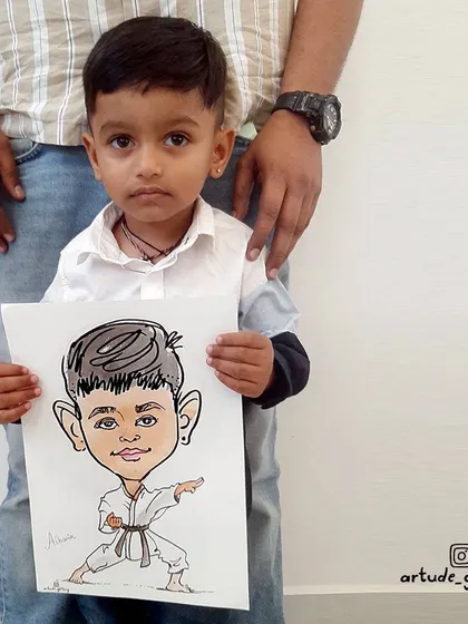 A future martial arts master! This little boy was thrilled to see himself in a karate uniform in his very own caricature.
