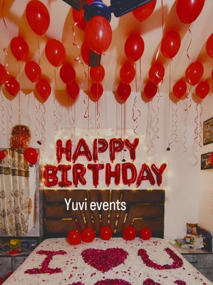 To add extra sparkle to the classic red balloon decoration, I can add a curtain of fairy lights behind the 'HAPPY BIRTHDAY' foil letters. This creates a warm and magical glow for your birthday surprise.