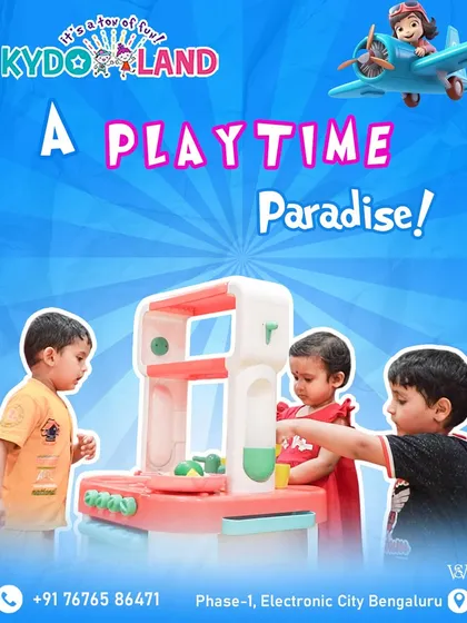 Welcome to a playtime paradise. Three toddlers are completely engaged with a toy kitchen set, demonstrating how our play area is designed for even the youngest explorers to learn and interact.