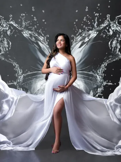 A goddess of water. This creative portrait combines a flowing white gown with a stunning water-splash effect that forms butterfly wings. It's a powerful and artistic representation of life and creation.