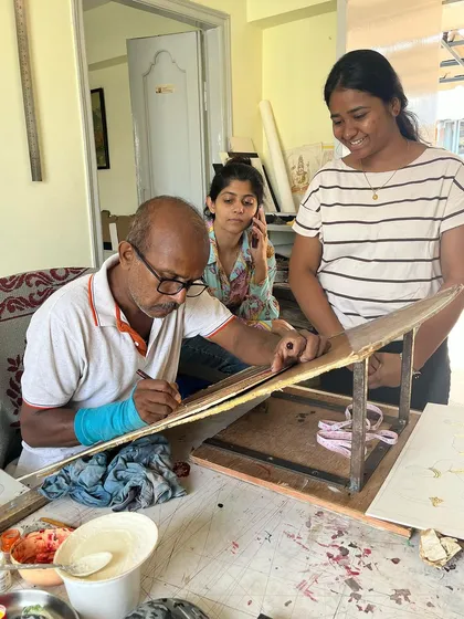 A typical day in our workshop. Here I am working on a piece while my daughter Amulya, who helps manage everything, and a visitor look on. It is a space of creation and collaboration.