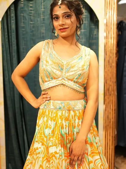 A closer look at our Haldi-perfect lehenga, showing the detailed embroidery on the blouse and the unique print of the skirt.