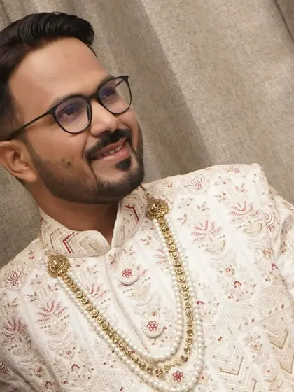A close-up portrait that highlights the clean makeup and sharp grooming. I focus on enhancing the groom's best features for a confident look.