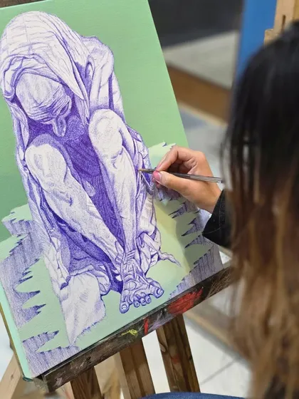 This close-up shot highlights the intricate cross-hatching technique used to create shadows and define the muscles on a figurative ballpoint pen drawing.
