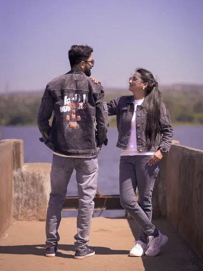 A stylish shot of a couple in matching denim jackets by the lake. This shows how we can do cool and modern pre-wedding photography.