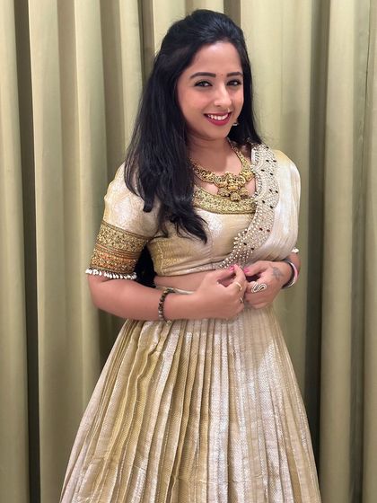 This shot shows the beautiful detailing on the blouse neckline and the elegant necklace.