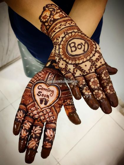 Another example of a baby shower design, with "Coming Soon" and "Boy" themes. I teach how to incorporate text and symbols effectively into your mehndi art.