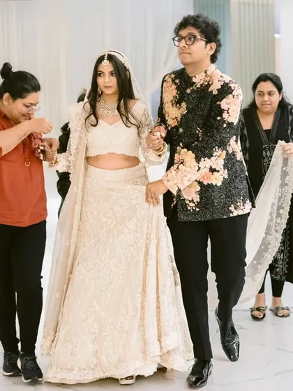 The bride and groom being prepped for their reception, a behind-the-scenes moment showing the team that helps create the magic.