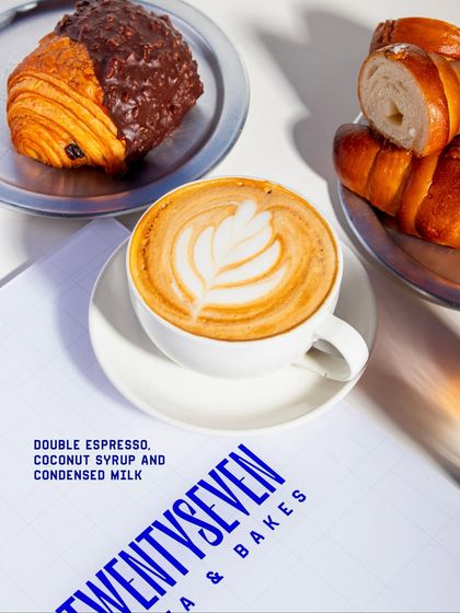 A hot Coconut Latte served alongside some of our fresh pastries, showcasing the perfect coffee and bake pairing.