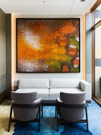 Our art curation service transforms commercial spaces into galleries. This abstract piece, installed in a lounge at the JW Marriott, demonstrates how we integrate fine art into luxury hospitality environments, creating an elevated experience for guests and new opportunities for our artists.