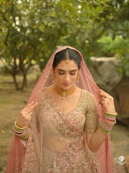 Vaishali's dreamy bridal portrait. The soft, diffused lighting highlights her minimal makeup and the delicate details of her pastel lehenga.
