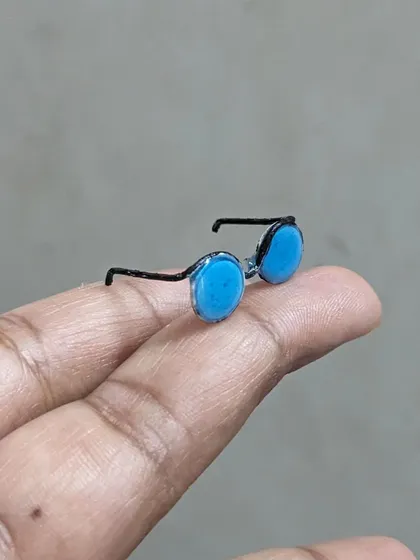 A teeny tiny pair of goggles, perfect for a custom figurine or a miniature scene.