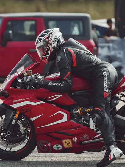 The moment before the launch. A rider on a red Ducati Panigale, focused and ready to unleash hell on the drag strip. This is what pure concentration looks like.