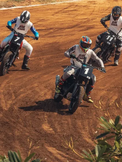 A pack of riders battling it out on the dirt track during the Slide School Cup. Flat track racing requires a unique set of skills that we also teach.