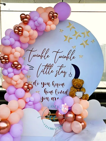 A dreamy "Twinkle Twinkle Little Star" theme for a baby shower. I designed a circular backdrop with custom text, surrounded by a pastel balloon arch in peach and lavender with rose gold accents, and finished with a teddy bear sitting on fluffy clouds.