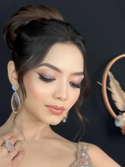 The perfect reception glam. This look features soft, shimmery eyeshadow, a glossy nude lip, and an elegant updo for a timeless and sophisticated style.