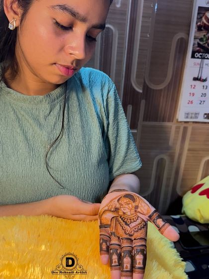 A client admiring her free mehndi trial. We offer this service to build trust and ensure you are completely satisfied.