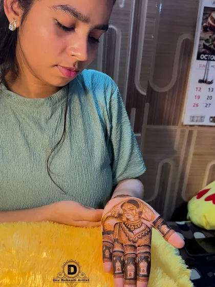 A client admiring her free mehndi trial. We offer this service to build trust and ensure you are completely satisfied.