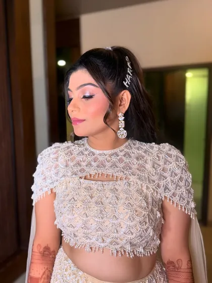 Let's add a personal touch to your Sangeet hairstyle. This trendy high ponytail is fun, comfortable for a night of dancing, and features a custom crystal clip with the groom's name for that unique detail.