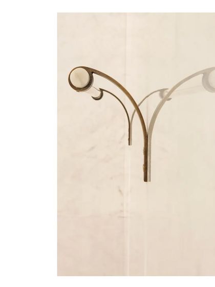 A custom wall sconce in aged brass, designed to cast a soft, warm light. Even the smallest elements are an opportunity for thoughtful design and beautiful craftsmanship.