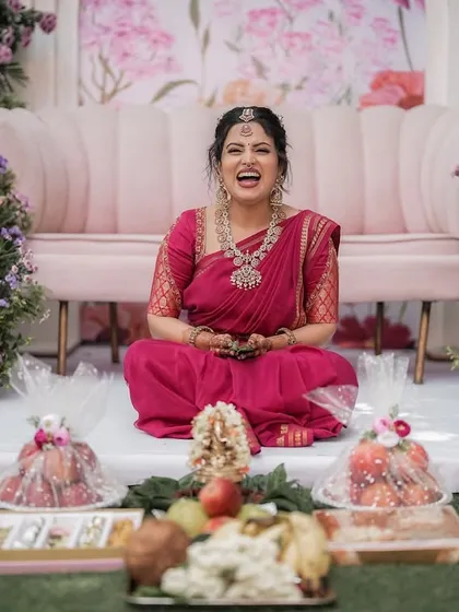 The joy on a bride's face is my greatest reward. Here, Anupa shares a laugh during her engagement ceremony, surrounded by decor that we planned together. It is these happy, personal moments that I strive to create.