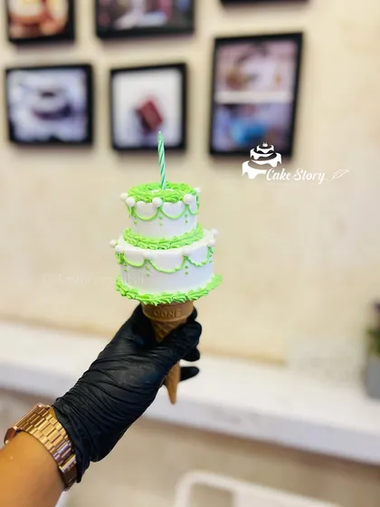 My trending cone cake. This fun and unique design features a mini two-tier cake served on top of an ice cream cone, perfect for a quirky celebration.