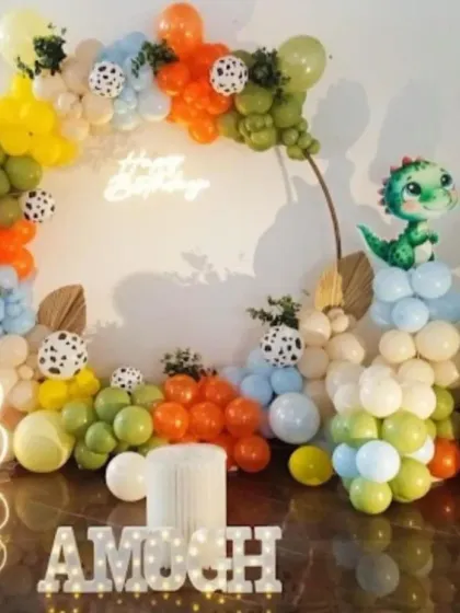 A cute and colorful dinosaur-themed 3rd birthday. The organic balloon arch in earthy tones is accented with dalmatian print balloons and adorable dinosaur cutouts.