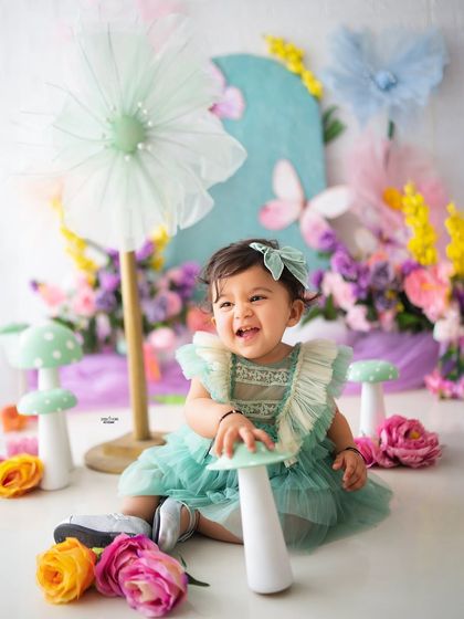Playing with the polka-dotted mushrooms in her enchanted garden. These interactive props make the session fun for the little ones.