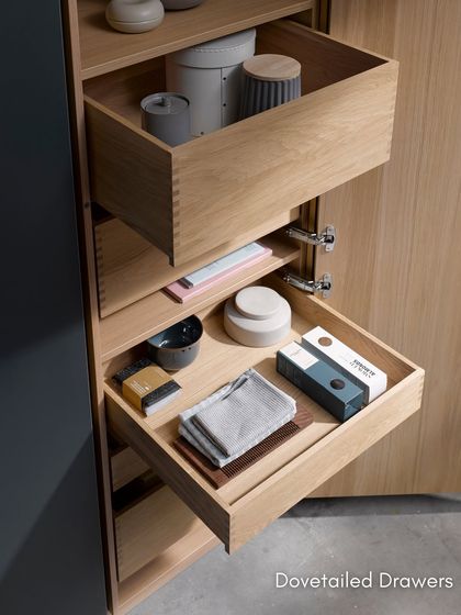 A detail of our dovetailed drawers in a light oak finish. This traditional joinery technique is a hallmark of quality craftsmanship, ensuring durability and strength.