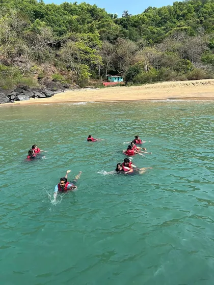 Travelers enjoying a safe and fun swim in the sea with life jackets, a popular activity on our Gokarna beach hopping tour.