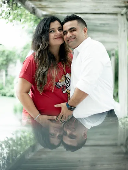 This is a creative double exposure shot, reflecting the couple in the water below them. It adds an artistic and dreamy quality to the maternity portrait, symbolizing their connection.