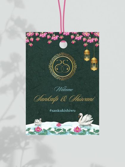 An exquisite luggage tag designed with an Indian lotus and swan theme. The rich green background and gold foil details make for a luxurious and practical favor for guests at a destination wedding.