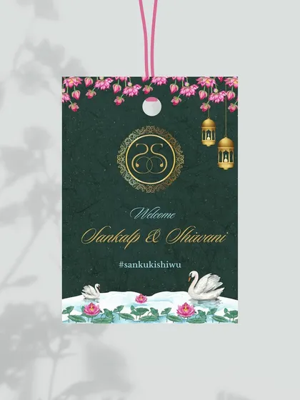 For a destination wedding, personalized luggage tags are a thoughtful touch. I designed these tags with an exquisite Indian lotus and swan theme against a deep green background, complete with the couple's monogram.
