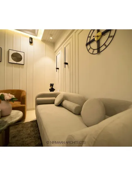 The foyer and living room at our Sushil Advait project. We used a curved sofa and simple, elegant furniture to create a welcoming and uncluttered space that feels both modern and timeless.