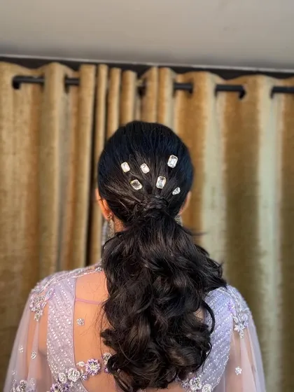 A close-up of the crystal-studded ponytail. It's a modern and chic hairstyle that's perfect for a bride who wants something different.