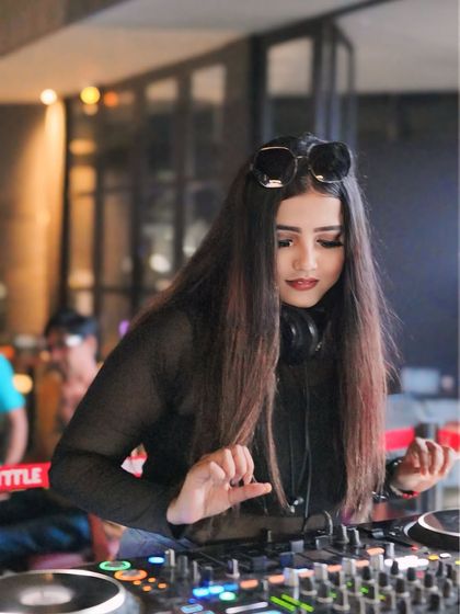 A candid moment while mixing at the console. I specialize in live sets that blend different genres to create a unique sound for each event.