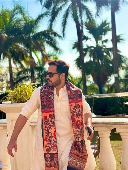 A stylish pose against the palm trees. This captures the destination wedding vibe.