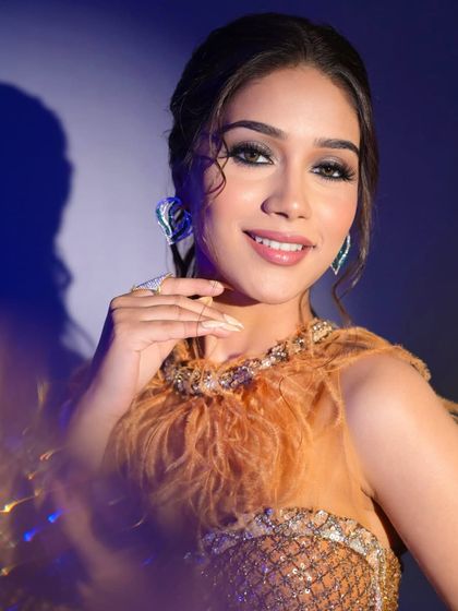 This glamorous look with a feathered top and smokey eyes is perfect for a cocktail party or sangeet. It's bold, modern, and makes a statement.