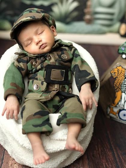 A close-up of our little soldier, sleeping soundly. The details of the camouflage outfit and cap are just adorable.